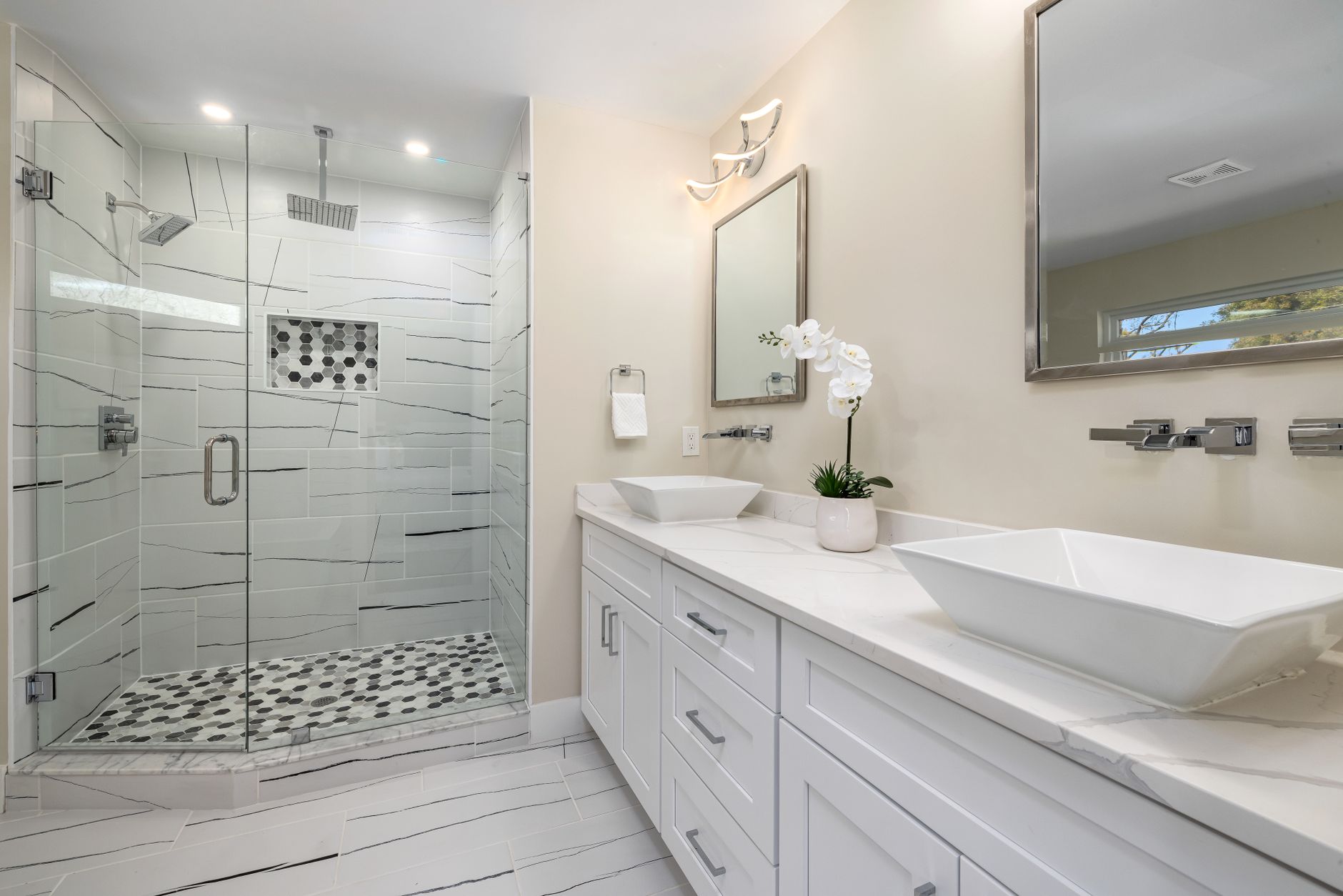 Luxurious contemporary bathroom featuring a spacious glass shower and dual sinks, perfect for stylish in Riverside, CA